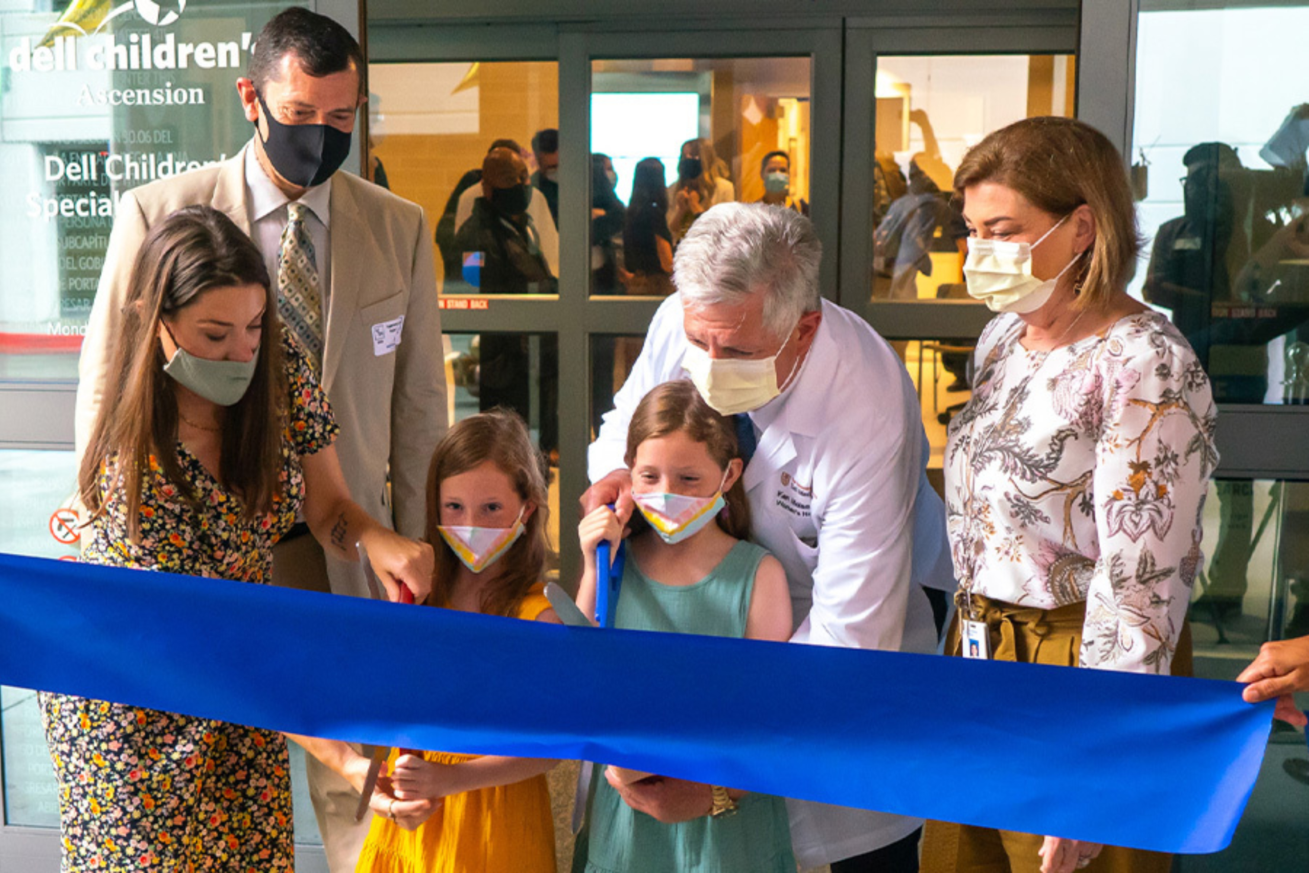 Dr. Kenneth Moise, Jr. is joined by former patient Amber Cessac and her twin daughters, Noelle and Edwin, to cut the ribbon at the opening ceremony for theComprehensive Fetal Care Center.