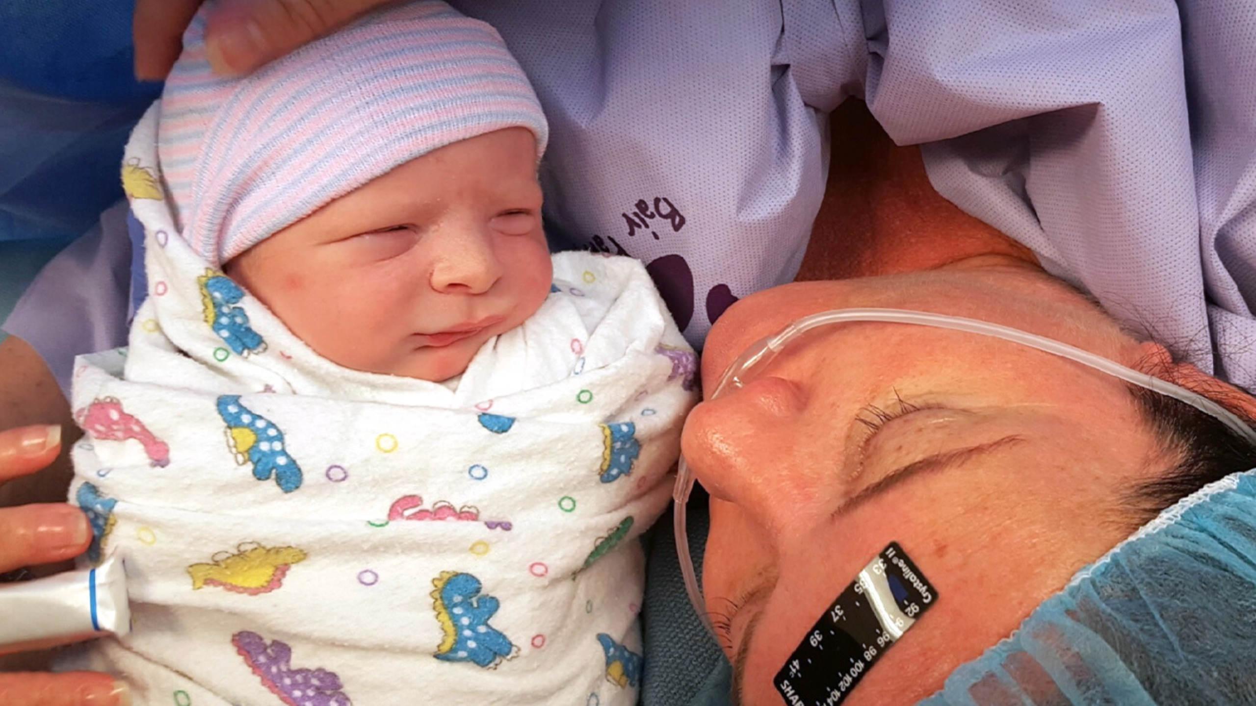 Levi Reeves as a newborn being held by his mother after delivery.