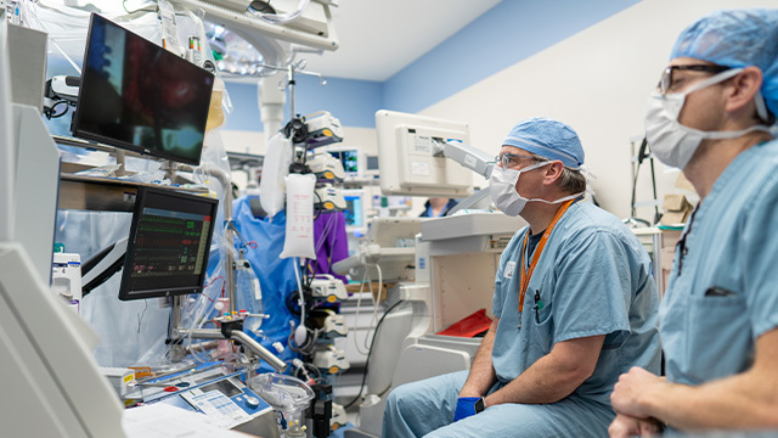 Two perfusionists monitoring cardiopulmonary bypass machine