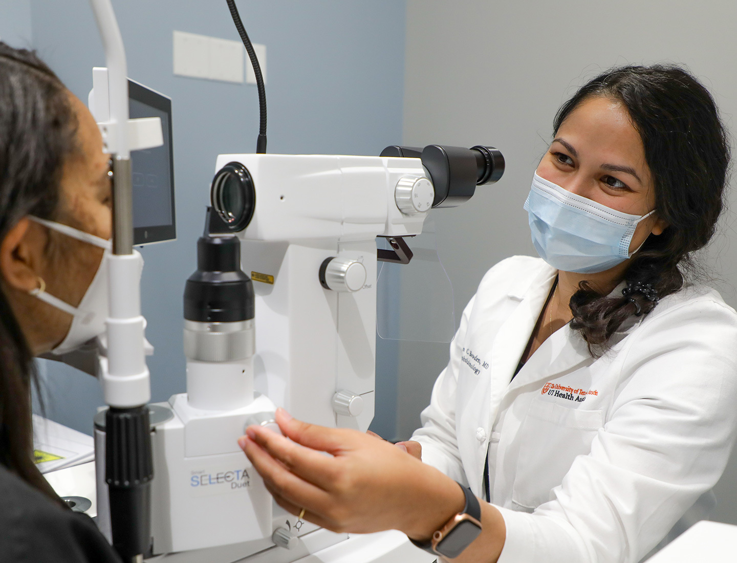 Ophthalmologist giving female patient eye exam