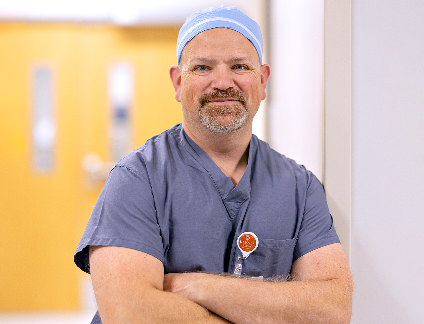 Karl Koenig, MD, wearing scrubs and a surgical cap.