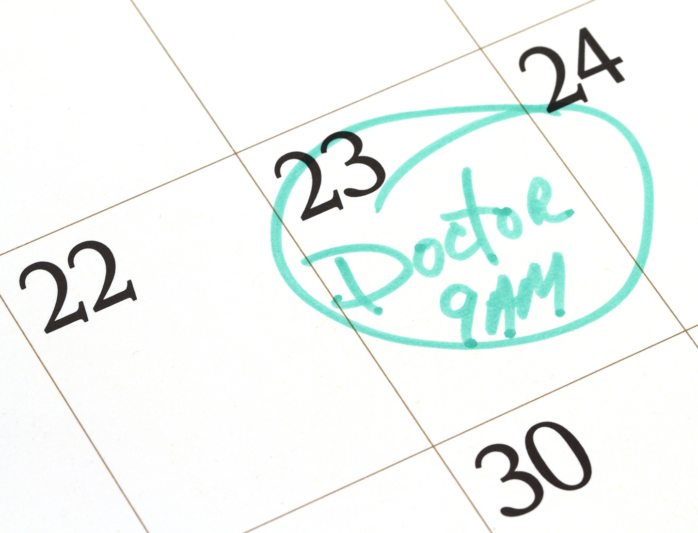 Dates on a calendar with "Doctor 9 AM" written and circled in green on the 23rd