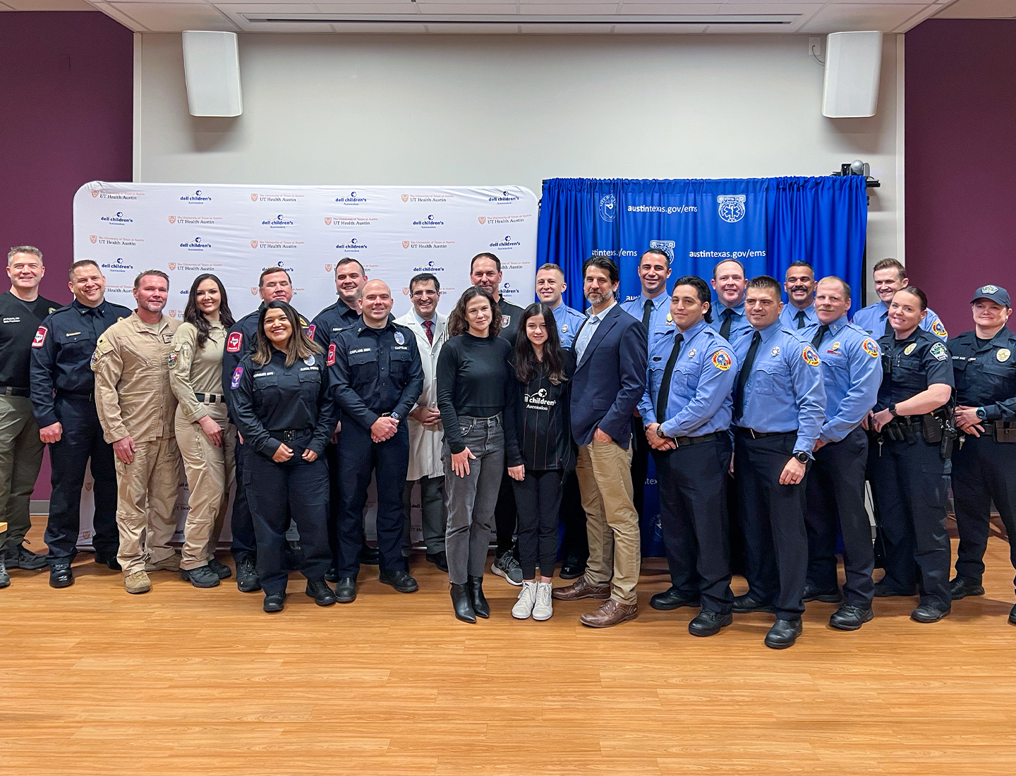 Sabine Barrett surrounded by her family, Dr. Carlos M. Mery, her soccer coach, and first responders.