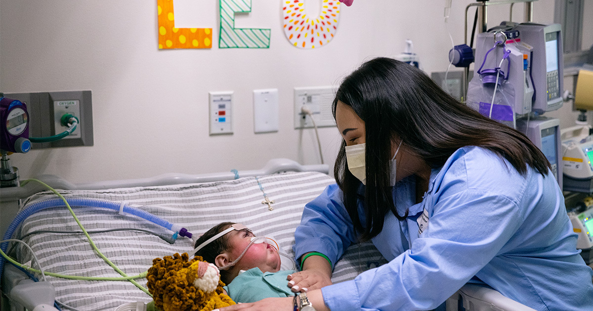 Leo Rodriguez in a hospital bed being attended to by a nurse.