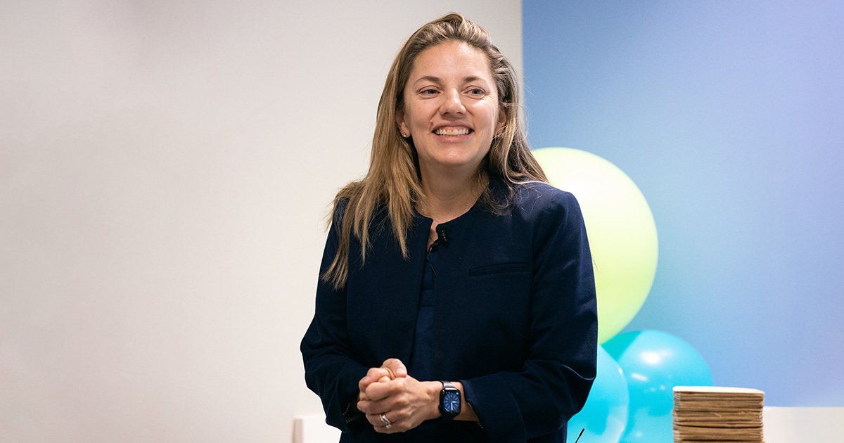 Chesney Castleberry MD, wearing a dark blue shirt and a smart watch and smiling.