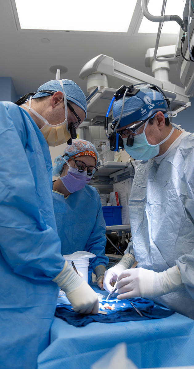 Surgeons performing a partial pediatric heart transplant.