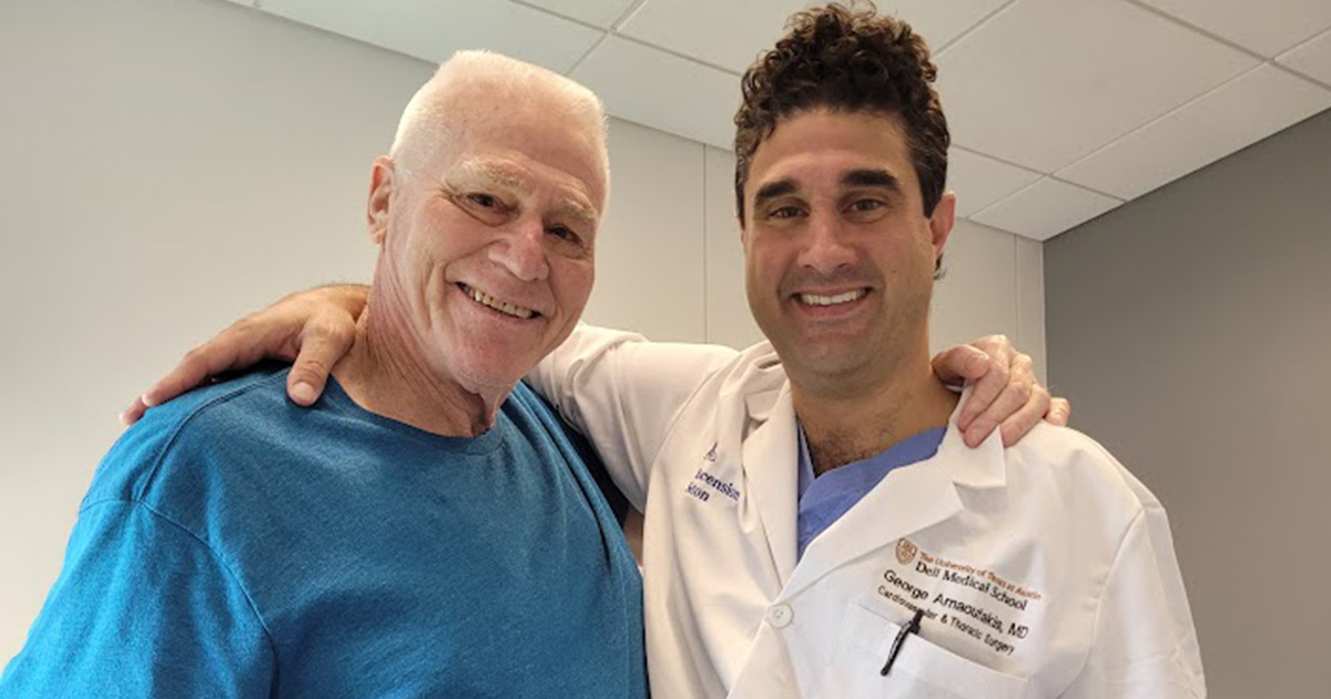 Coach Neil Gruber smiling with former student, cardiothoracic surgeon George Arnaoutakis, MD.