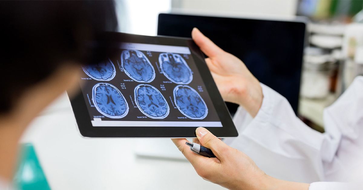 Doctor showing brain scans to patient