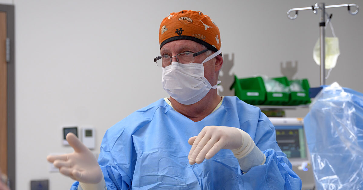 Dr. Kenneth J. Moise, Jr., wearing a surgical cap, gloves, gown and mask in the operating room.