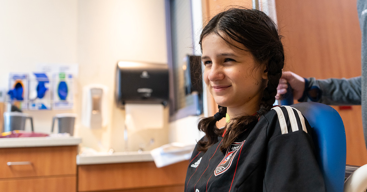 Sabine Barrett wearing her soccer uniform in a doctor's office after surgery.