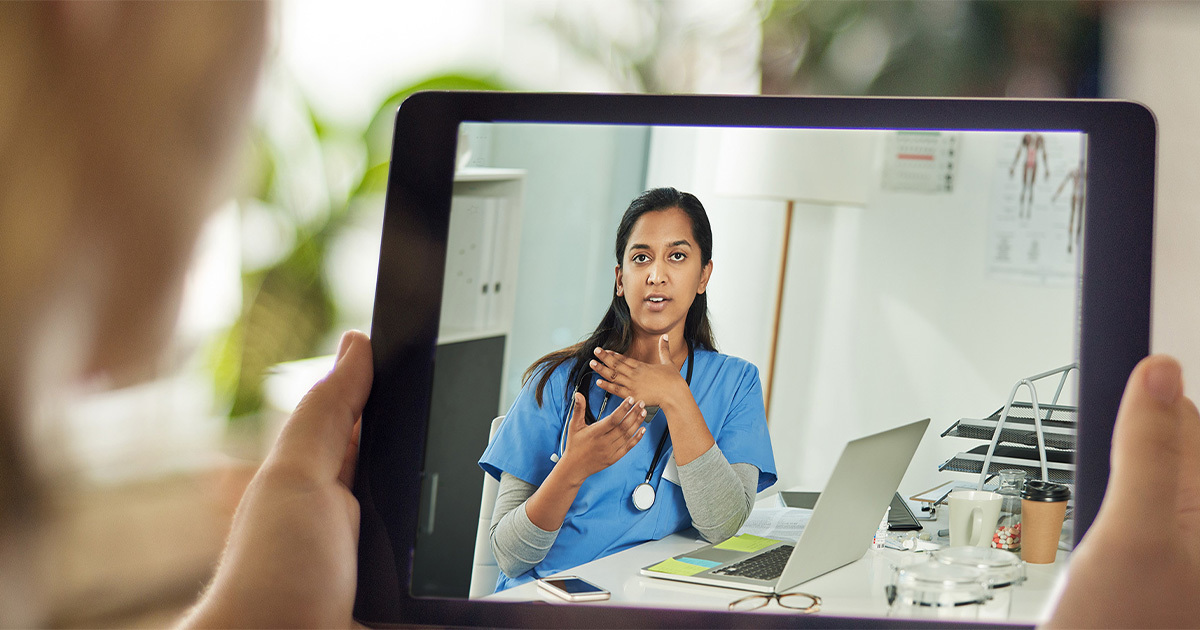 Woman talking to female medical provider via telemedicine