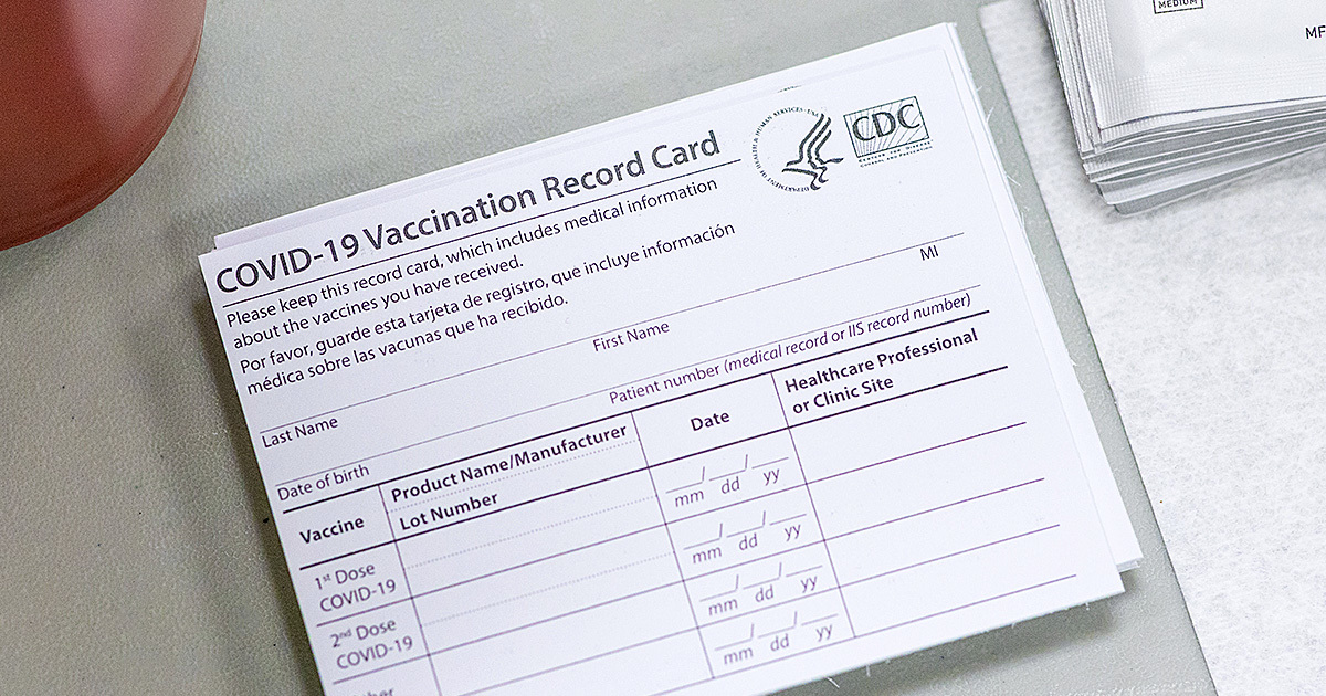 A close-up of a CDC official COVID-19 vaccination record card.