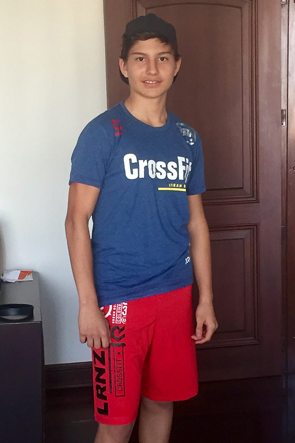 Teenager Lorenzo, a former patient of pediatric cardiologist Dr. Charles Fraser, wears his Crossfit tee shirt and is now an active teen.