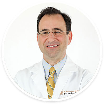 Neurologist David Paydarfar, MD, wearing a white coat and smiling in front of a white backdrop.