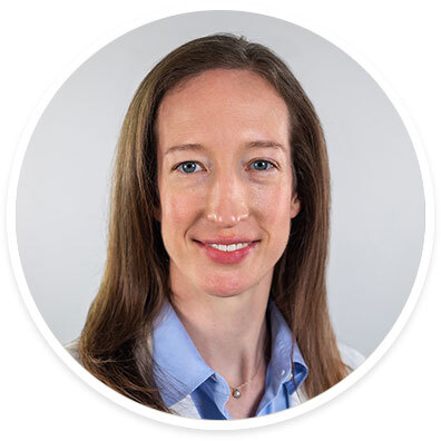 Pediatric neurologist Louisa Keith, MD, wearing a white coat and smiling in front of a white backdrop.