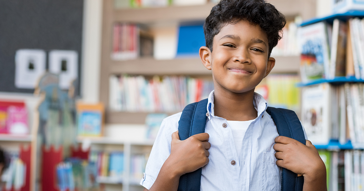 Young boy smiling while in school