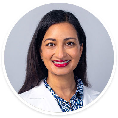 A portrait of Roshni Koli, MD, pediatric psychiatrist, in a round frame.