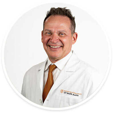 Cardiothoracic surgeon William Kessler, MD, FACS, wearing a white coat and smiling in front of a white backdrop.