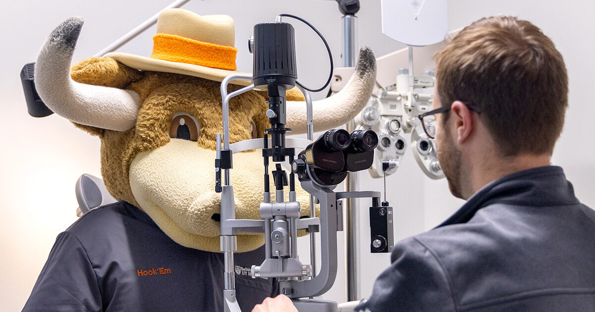 Hook Em, the costumed mascot for The University of Texas, receiving an eye exam.