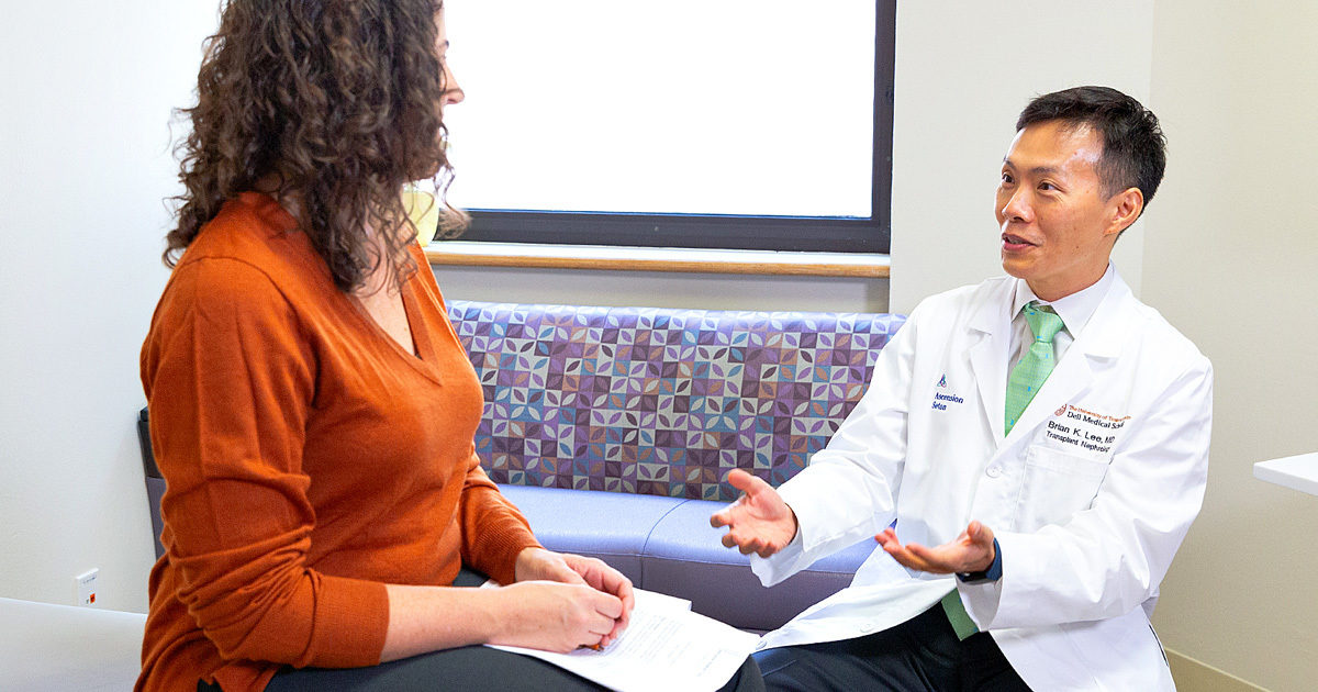 A patient is seated in an exam room with transplant surgeon Brian Lee, MD who is discussing the visit.