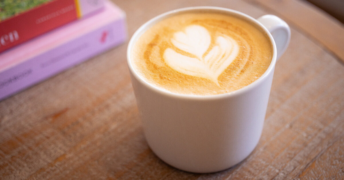 Latte with a flower design made of creamer.