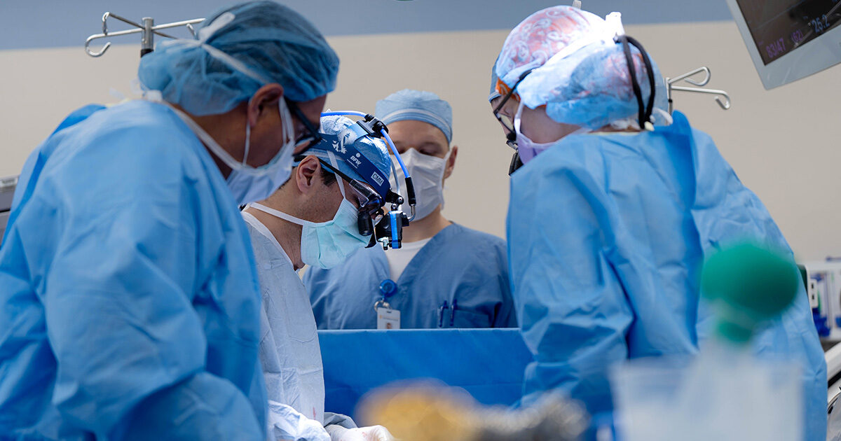 Surgeons performing a partial pediatric heart transplant.