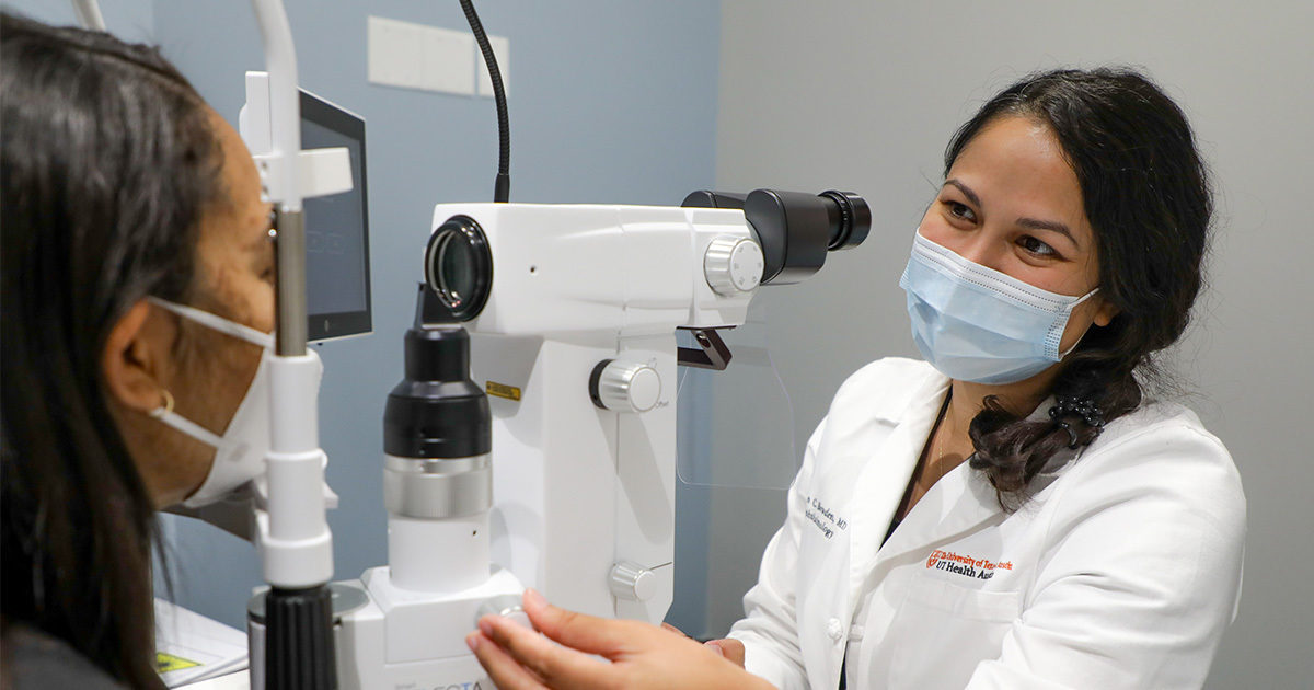 Ophthalmologist giving female patient eye exam