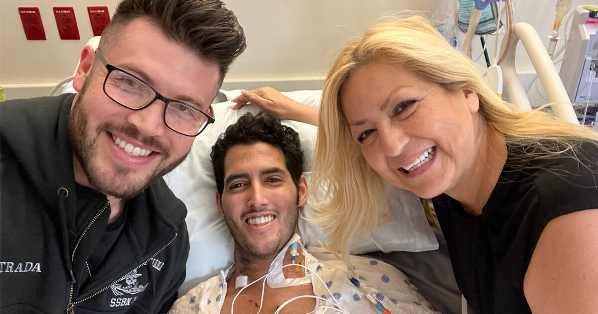 Abraham surrounded by his brother and mother in the the hospital.