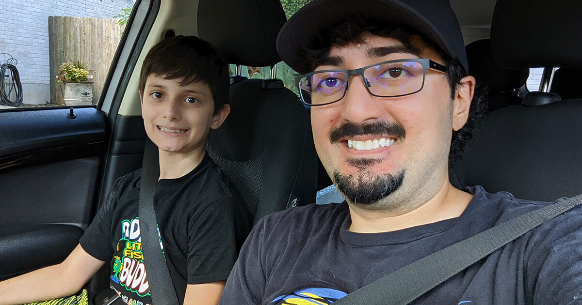 Joseph Yousefi sits with his son in their car.