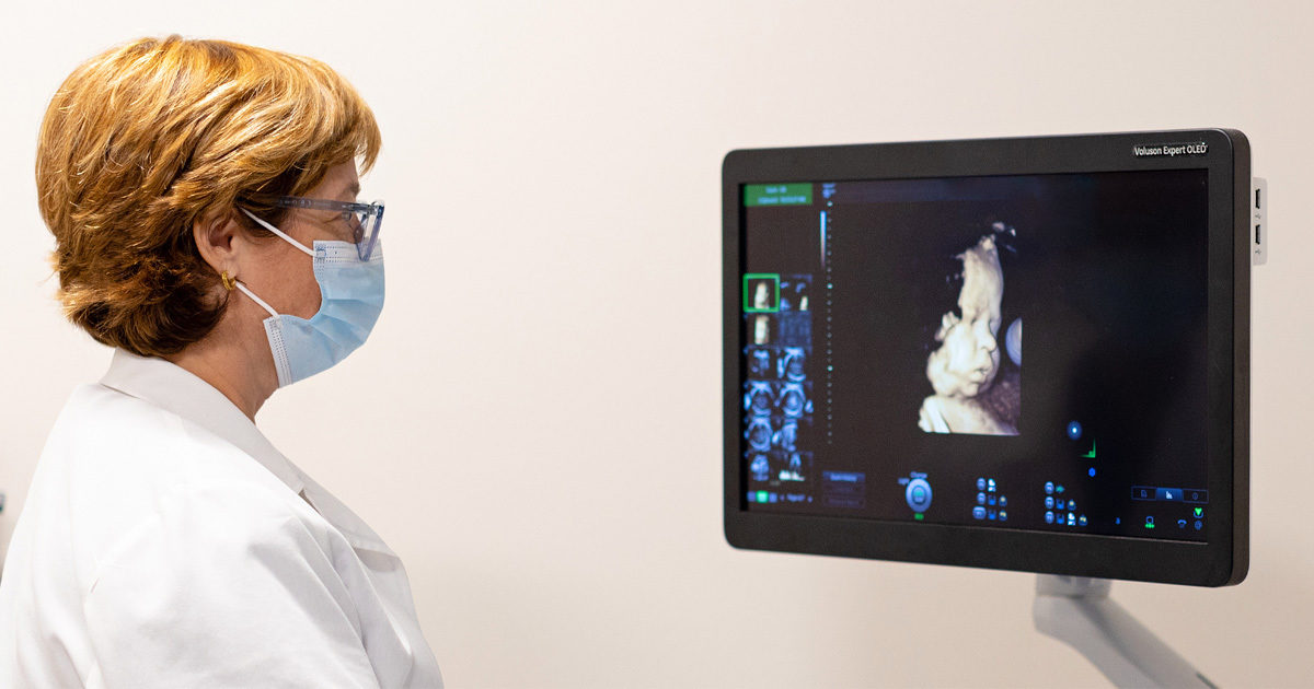 Celeste Sheppard, MD, a maternal fetal medicine specialist, reviews an ultrasound image of a fetus during an exam.