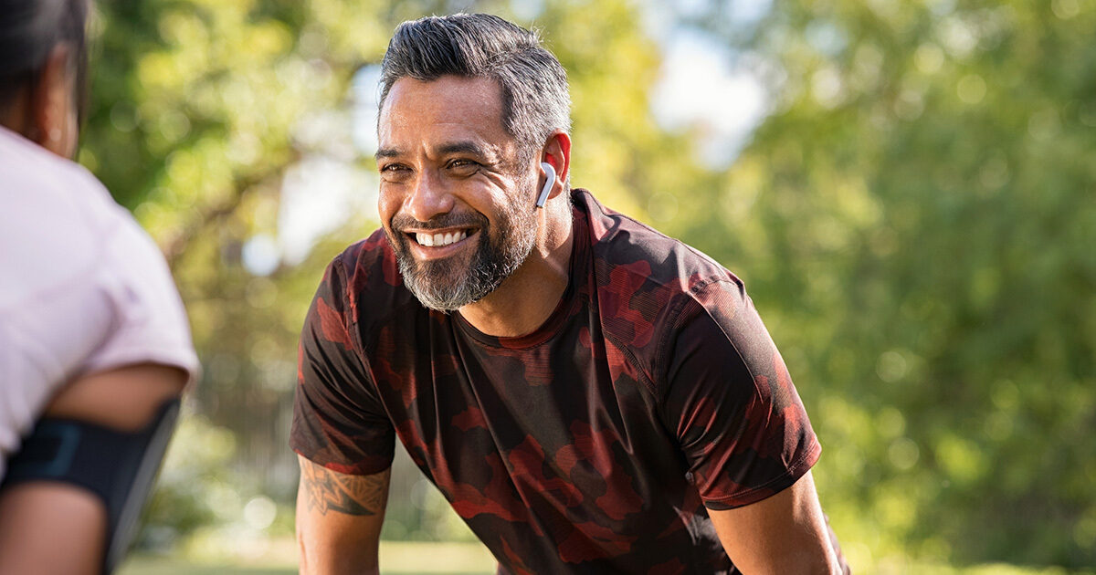 A man in red camouflage activewear participates in sports outdoors.