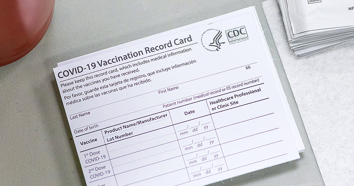 A close-up of a CDC official COVID-19 vaccination record card.