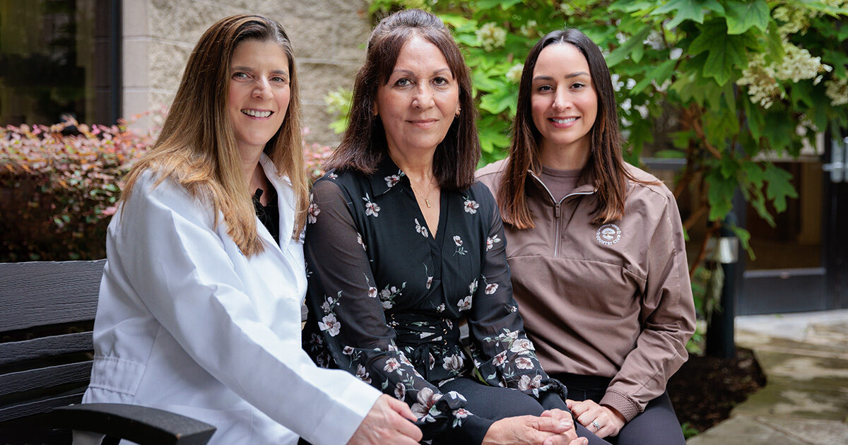 Nicole Turgeon, MD, FACS, posing outdoors with patient Julie and her daughter Kelli.