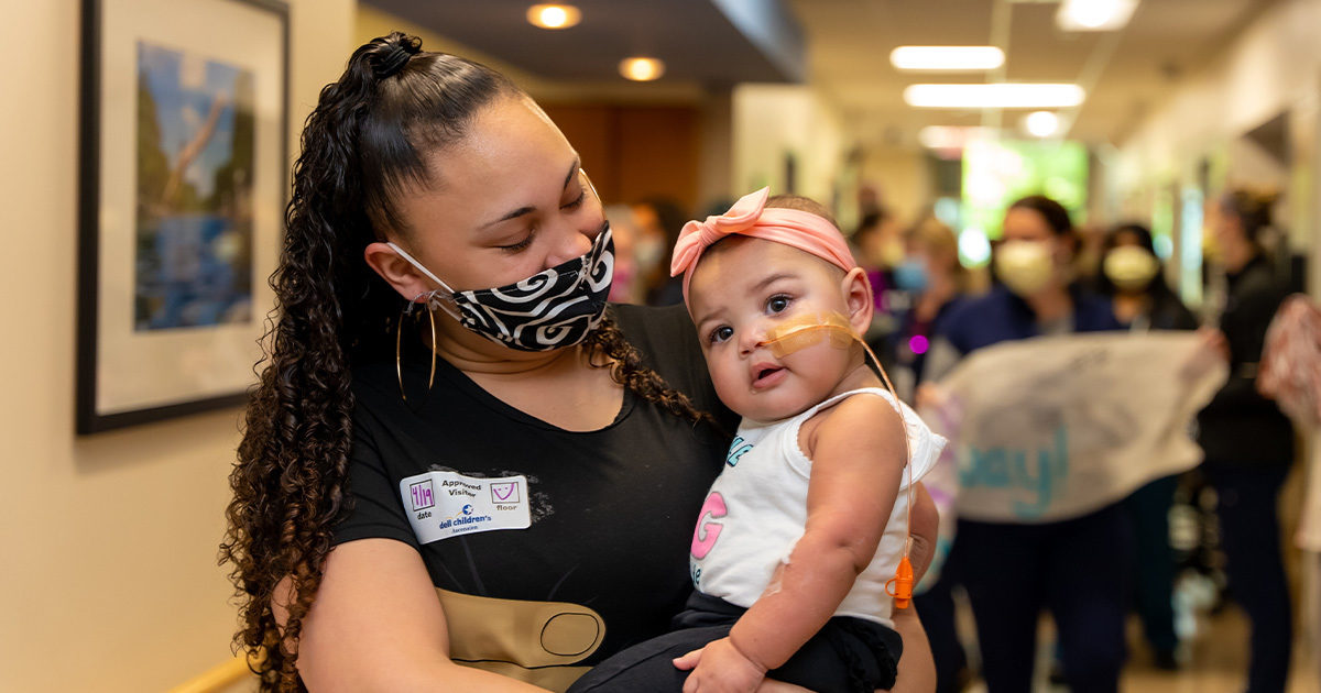 Zaria Jackson held by her mother after recovering from heart surgery