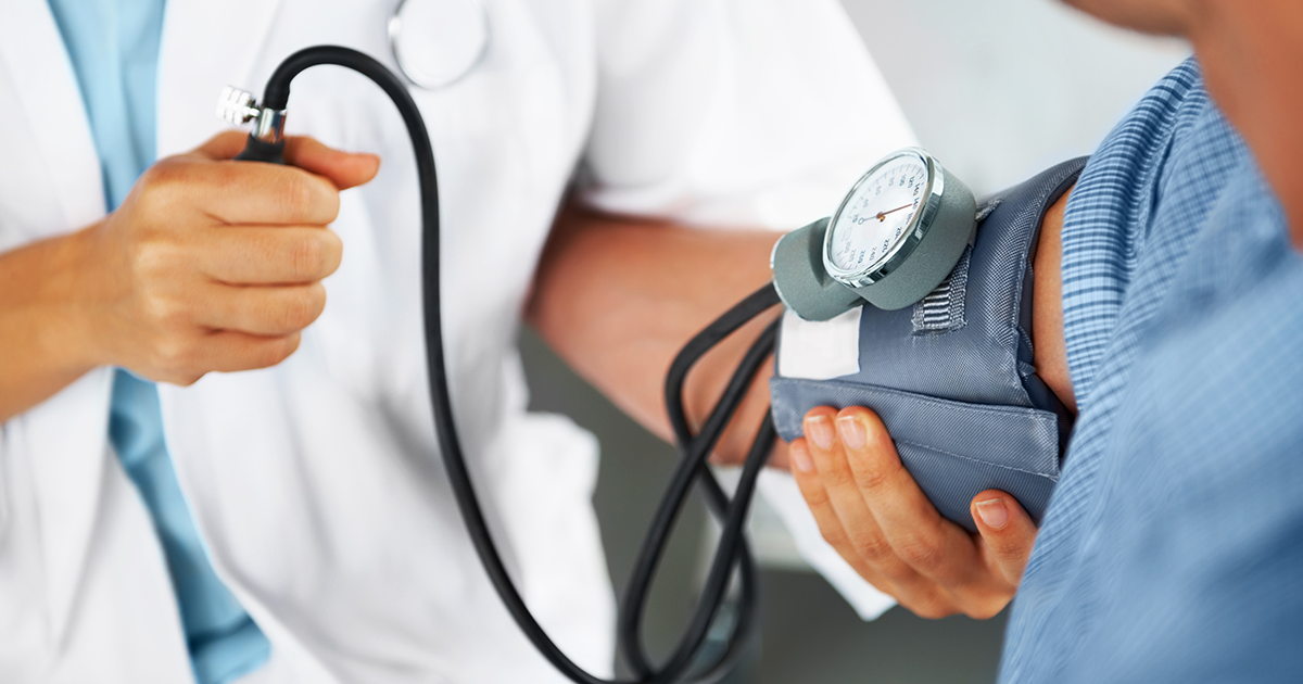 Patient having their blood pressure measured by a doctor.