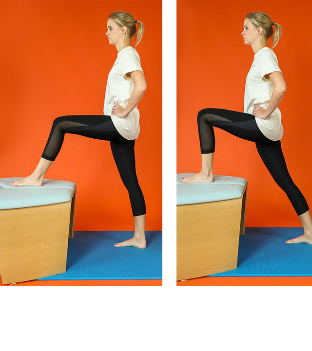 A standing woman stretches her hip flexors by placing her foot on an elevated surface and leaning forward