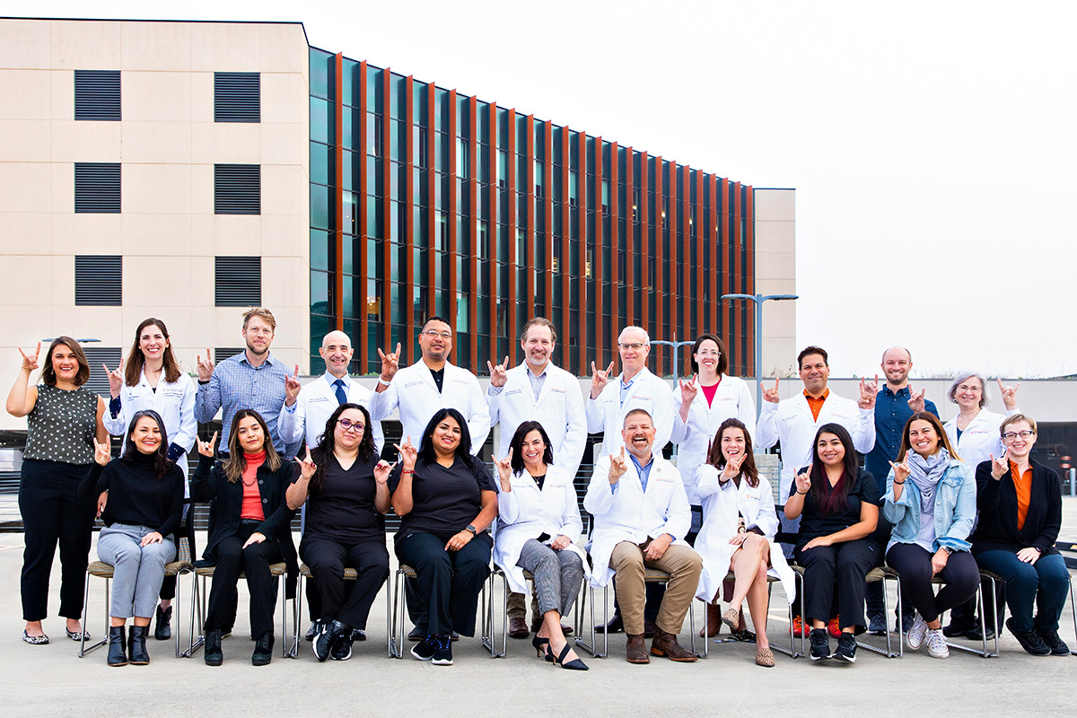 21 members of the UT Health Austin Musculoskeletal Institute staff are gathered in rows for a group photograph.