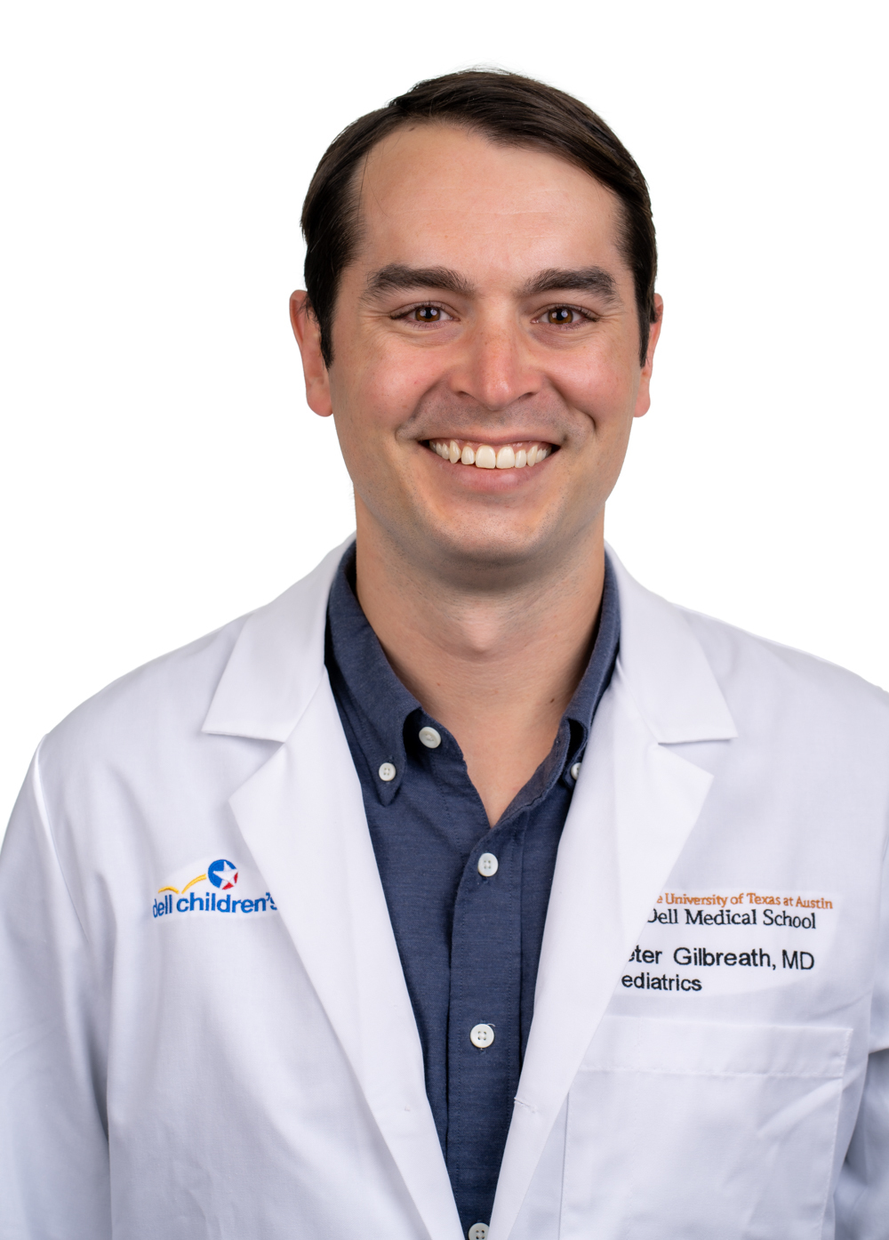 Pediatric hospitalist Peter Gilbreath, MD, wearing a white coat and smiling in front of a white backdrop.