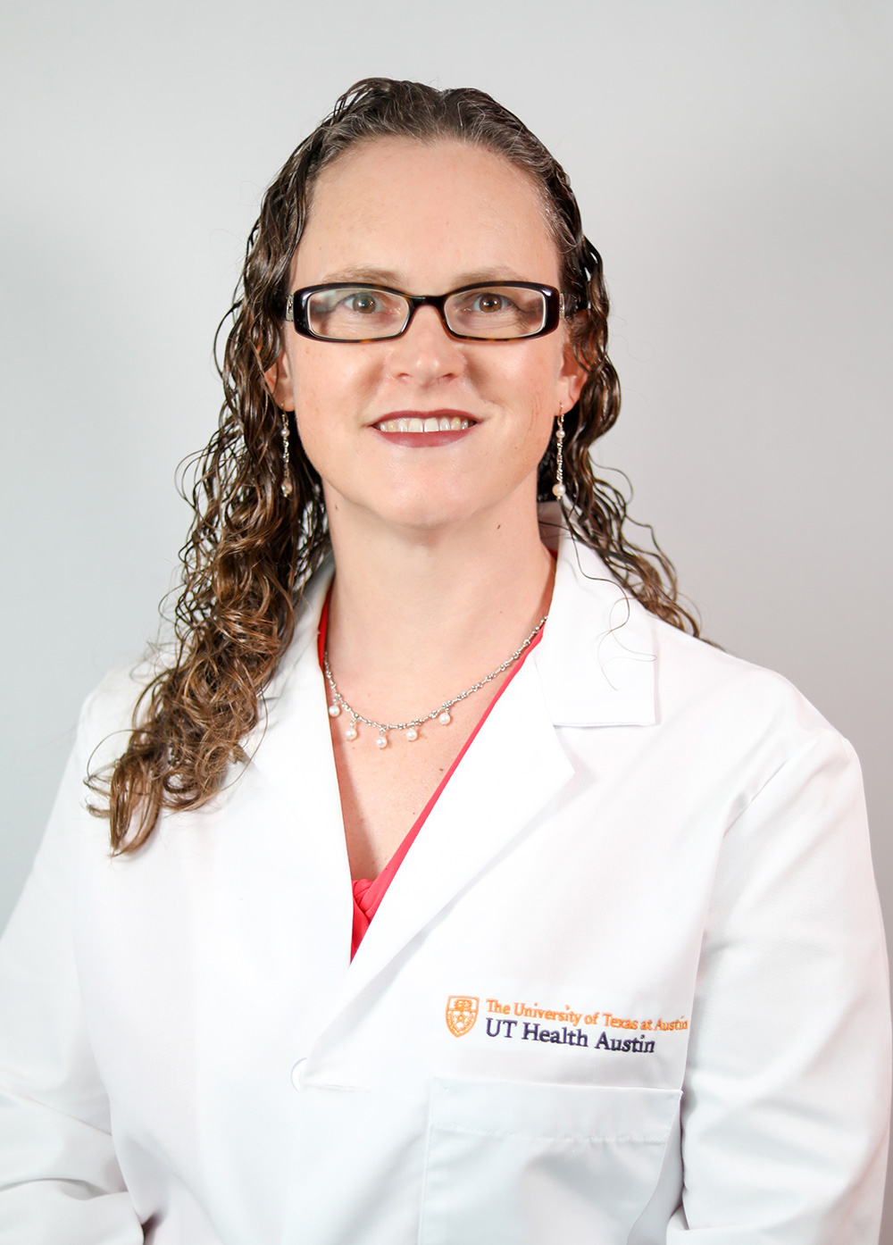 Gastroenterologist Linda Feagins, MD, wearing a white coat and smiling in front of a white backdrop.