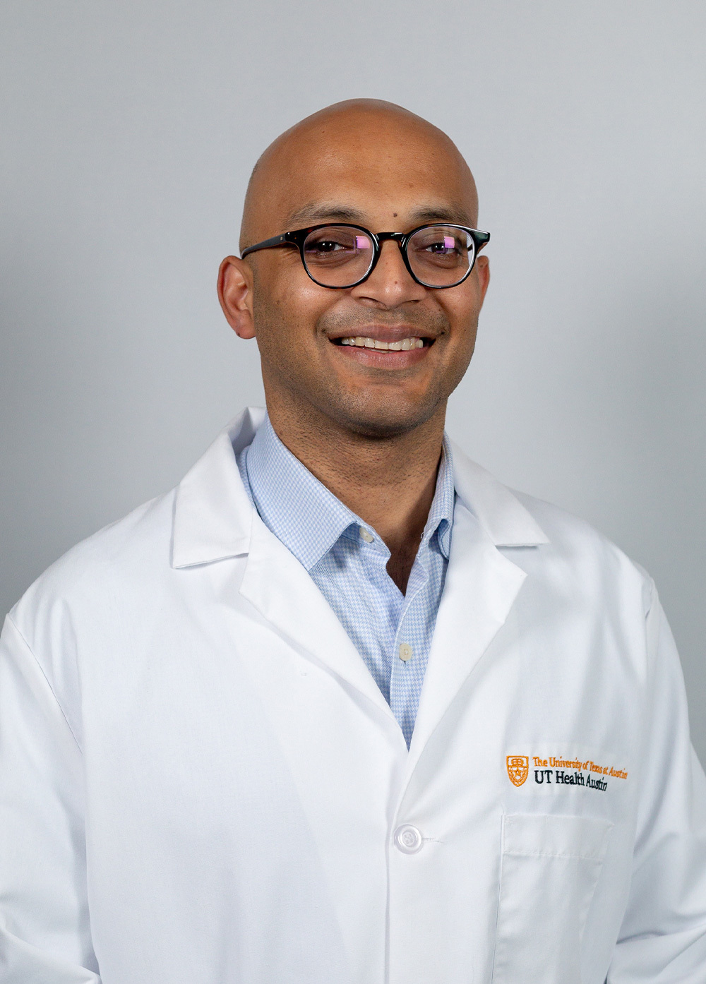 Gastroenterologist Deepak Agrawal, MD, MPH, wearing a white coat and smiling in front of a white background.