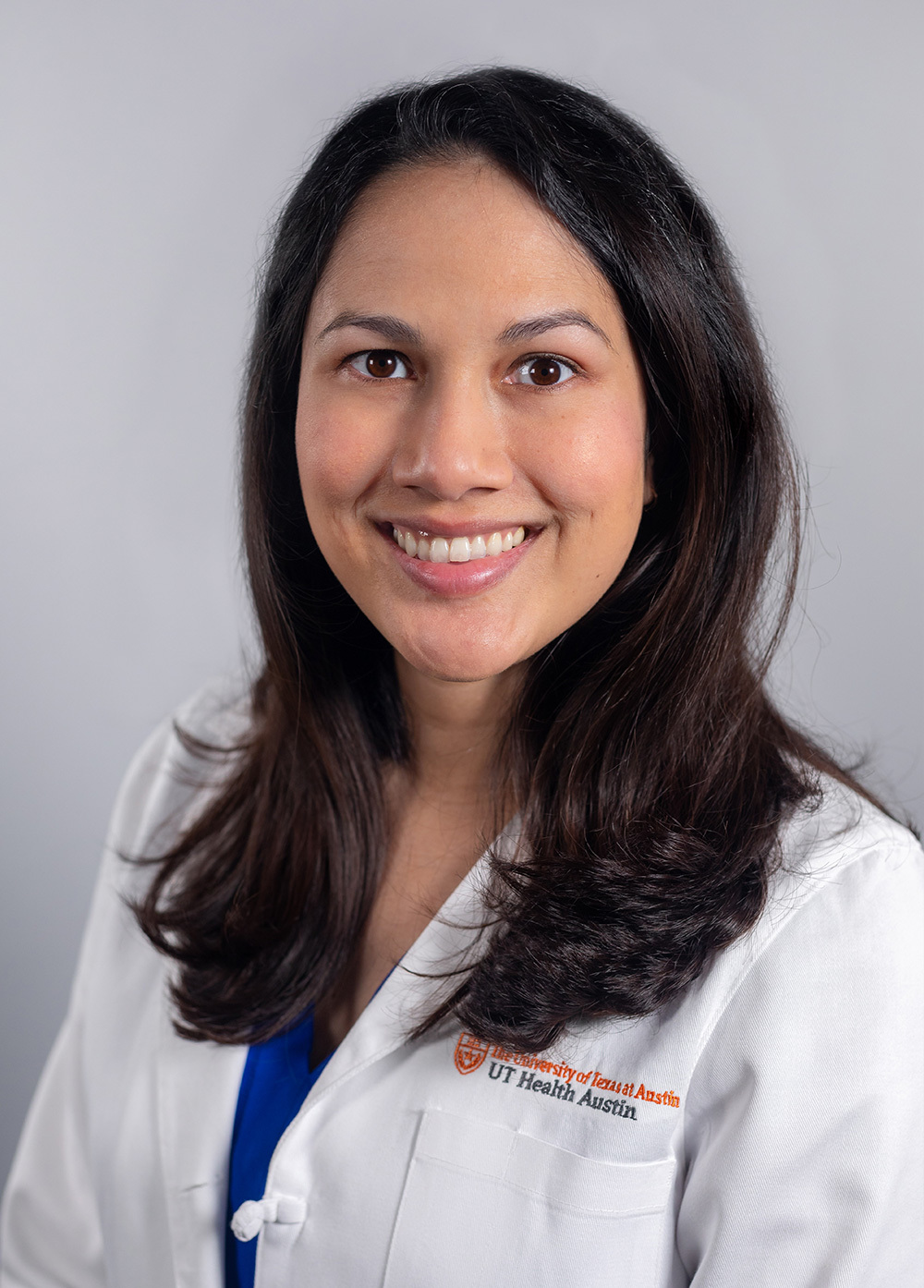 Ophthalmologist Eileen Bowden, MD, wearing a white coat and smiling in front of a white backdrop.