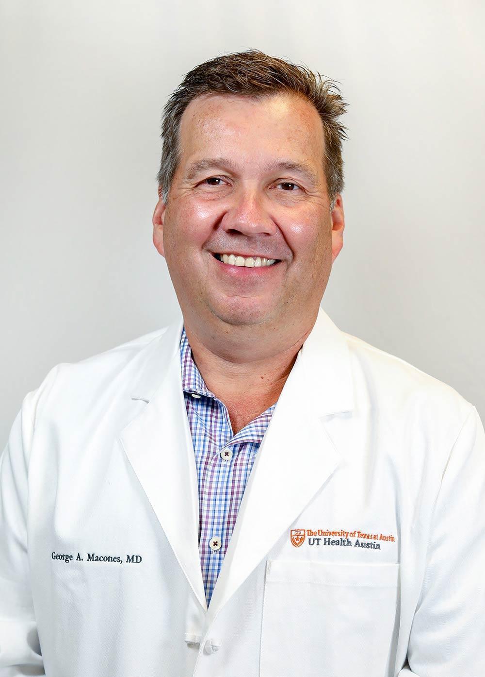 Obstetrician-gynecologist George A. Macones, MD, MSCE, wearing a white coat and smiling in front of a white backdrop.