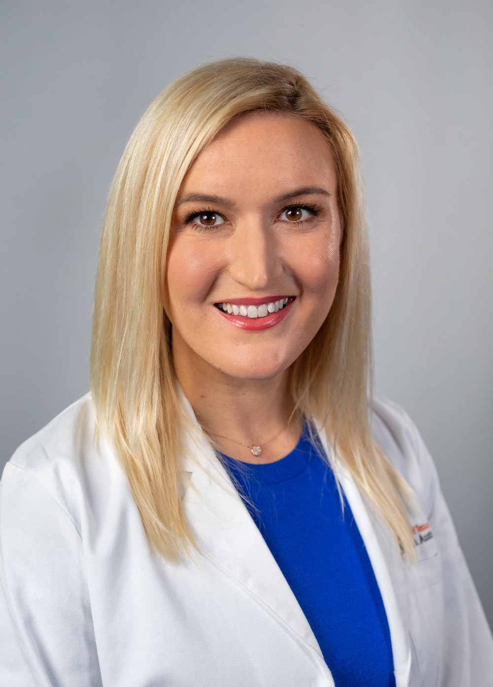 Maternal-fetal medicine specialist S. Lindsay Wood, MD, wearing a white coat and smiling in front of a white backdrop.