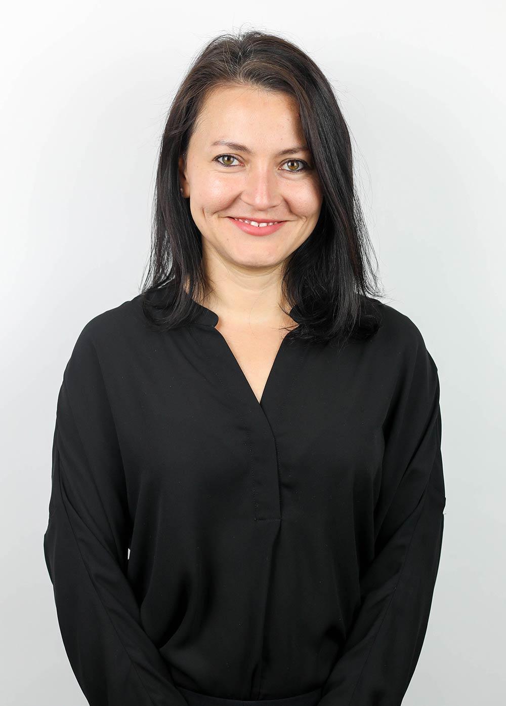 Nutritionist Lizette Taboada, RD, LD, wearing a black blouse and smiling in front of a white backdrop.