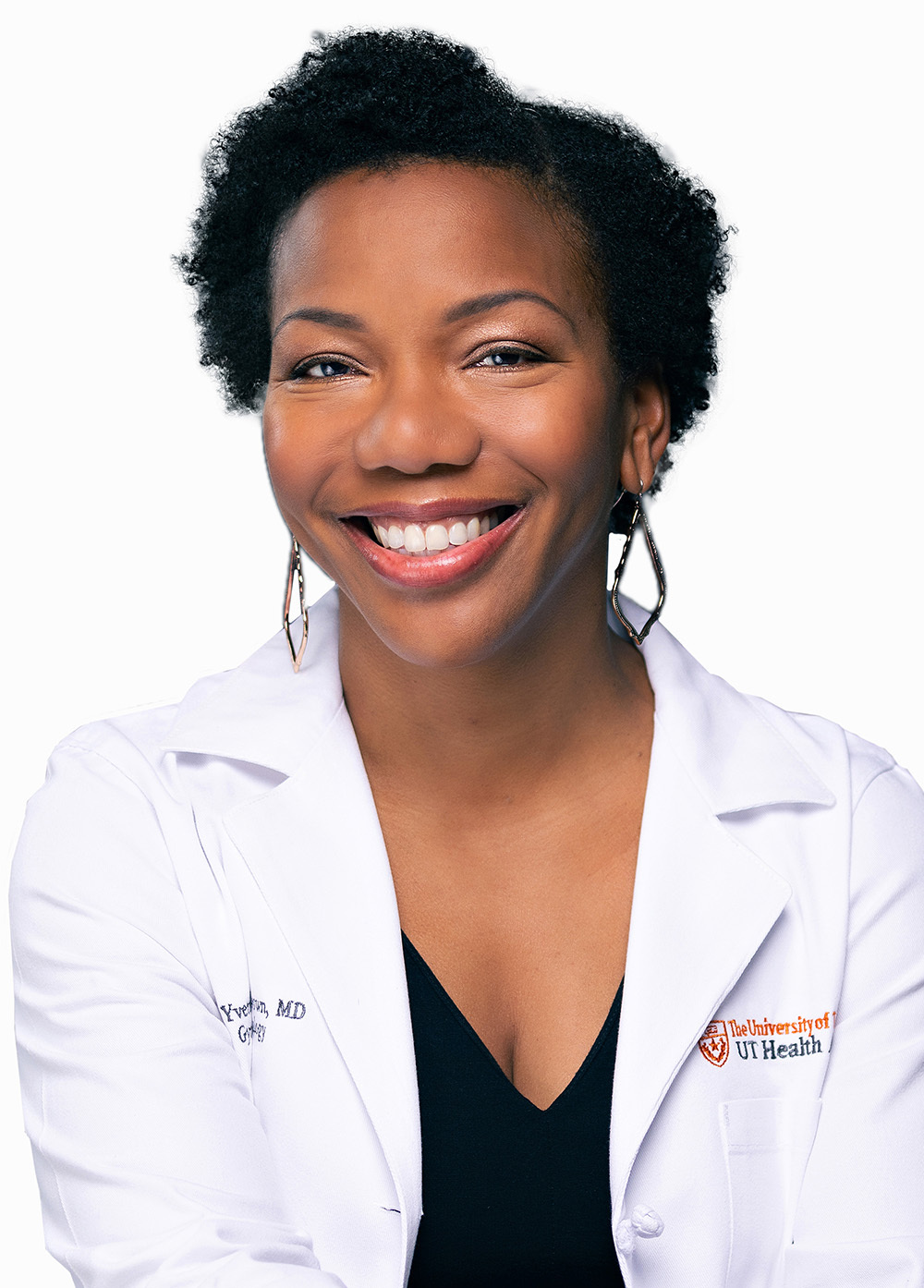 Gynecologic oncologist M. Yvette Williams-Brown, MD, MMS, FACOG, wearing a white coat and smiling in front of a white backdrop.