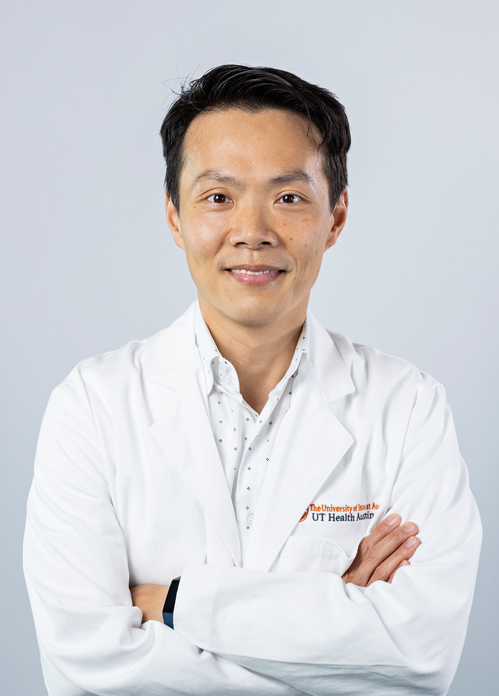 Transplant nephrologist Brian K. Lee, MD, wearing a white coat and smiling in front of a white backdrop.