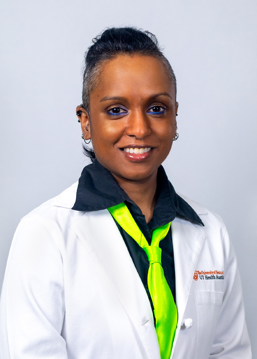 Pediatric cardiac critical care intensivist Camille N. Immanuel, MD, MHS, wearing a white coat and smiling in front of a white backdrop.