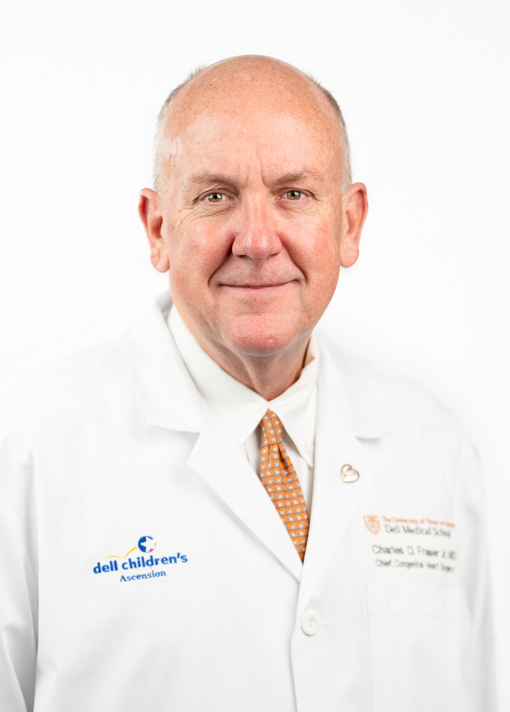 Dr. Charles D. Fraser, Jr., wearing a white coat and smiling in front of a white backdrop.