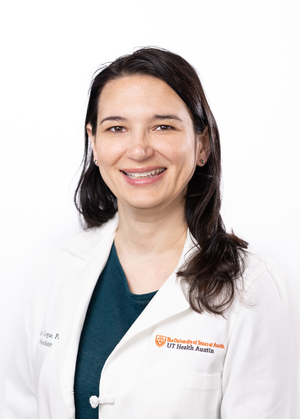 Dr. Erin Logue earing a white coat and smiling in front of a white backdrop.