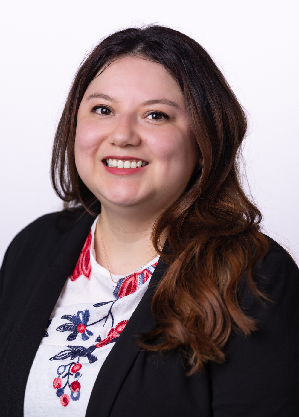 Francis Ibarra, UT Health Austin Social worker stands against a white background smiling.